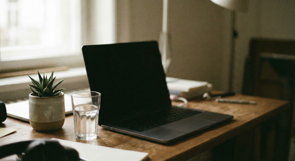 Desk with laptop and glass of water